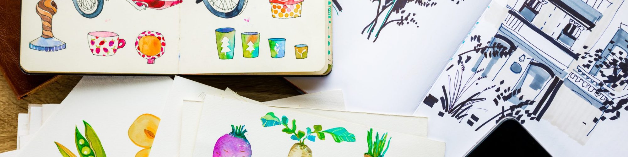 top view of watercolor drawings and smartphone